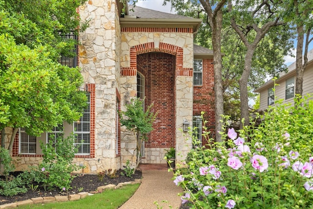 3340 Castlewood Blvd, Highland Village, TX 75077 - doorway to property with brick siding, a shingled roof, and stone siding