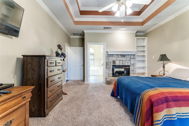 2206 Virginia Ln, Haslet, TX 76052 - bedroom featuring a raised ceiling, light colored carpet, ornamental molding, ensuite bath, and a fireplace
