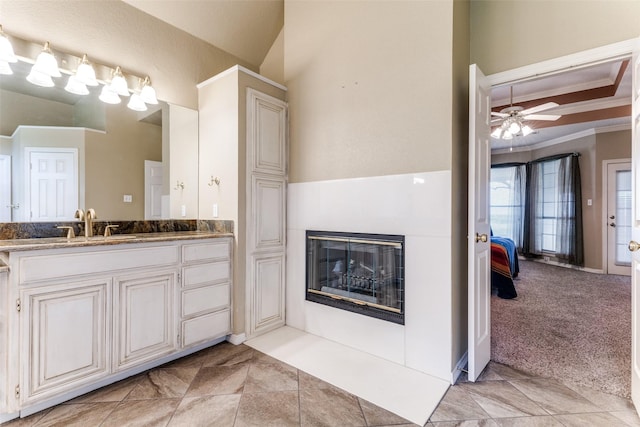 2206 Virginia Ln, Haslet, TX 76052 - bathroom featuring vanity, crown molding, a glass covered fireplace, ceiling fan, and ensuite bathroom