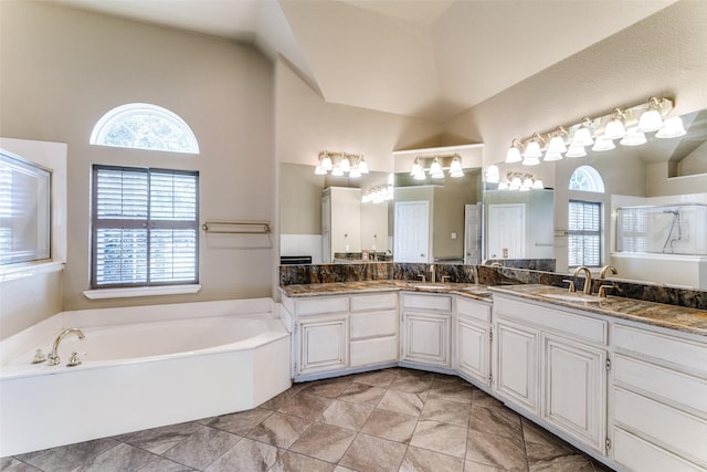 2206 Virginia Ln, Haslet, TX 76052 - bathroom featuring a garden tub, double vanity, high vaulted ceiling, a shower, and tile patterned floors