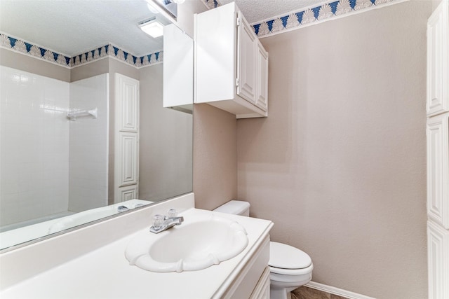 2206 Virginia Ln, Haslet, TX 76052 - bathroom featuring toilet, vanity, a textured ceiling, and a tile shower