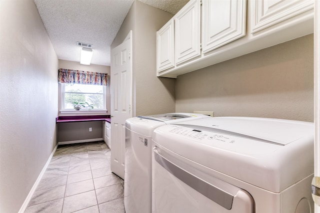 2206 Virginia Ln, Haslet, TX 76052 - washroom featuring cabinet space, washer and clothes dryer, a textured ceiling, baseboards, and light tile patterned flooring