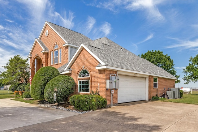 2206 Virginia Ln, Haslet, TX 76052 - traditional-style house with driveway, roof with shingles, a garage, brick siding, and cooling unit