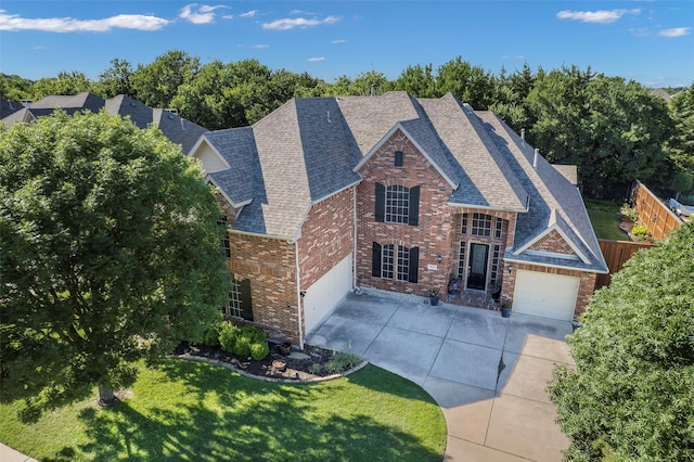 7811 Keith Ln, Sachse, TX 75048 - view of front of home featuring brick siding, concrete driveway, roof with shingles, and a garage