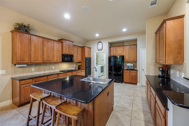 7811 Keith Ln, Sachse, TX 75048 - kitchen with black appliances, a sink, decorative backsplash, brown cabinets, and recessed lighting