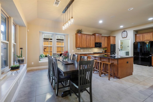 7811 Keith Ln, Sachse, TX 75048 - dining area with vaulted ceiling, healthy amount of natural light, light tile patterned floors, recessed lighting, and baseboards