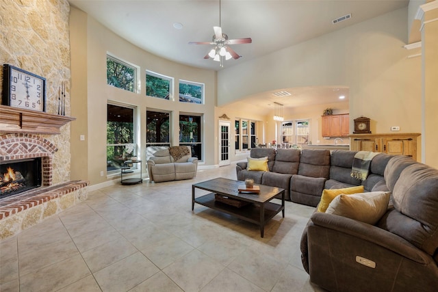 7811 Keith Ln, Sachse, TX 75048 - living room with a towering ceiling, a ceiling fan, light tile patterned floors, and a fireplace
