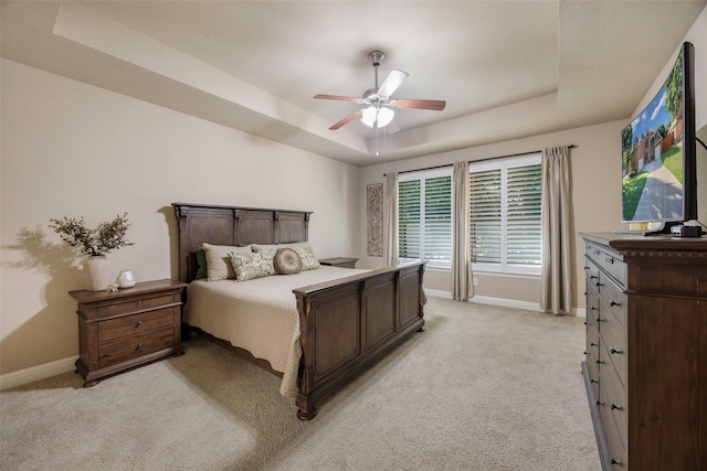 7811 Keith Ln, Sachse, TX 75048 - bedroom featuring a tray ceiling, baseboards, light colored carpet, and ceiling fan