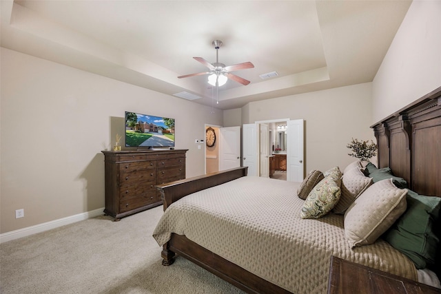7811 Keith Ln, Sachse, TX 75048 - bedroom featuring a tray ceiling, light colored carpet, baseboards, a ceiling fan, and connected bathroom