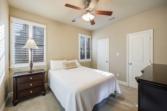 7811 Keith Ln, Sachse, TX 75048 - bedroom featuring light carpet, baseboards, multiple windows, and ceiling fan