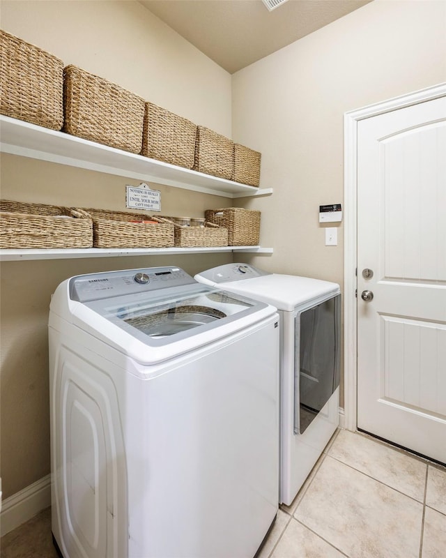 7811 Keith Ln, Sachse, TX 75048 - laundry area with washing machine and dryer, light tile patterned floors, and baseboards