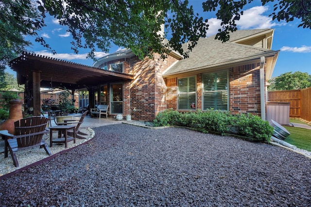 7811 Keith Ln, Sachse, TX 75048 - back of house with brick siding, roof with shingles, and a patio area