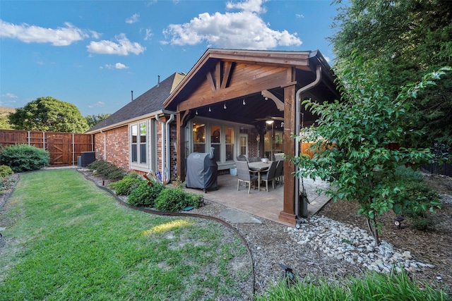 7811 Keith Ln, Sachse, TX 75048 - back of property with a patio area, brick siding, a shingled roof, and a gate