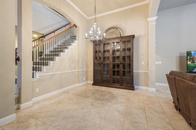 7811 Keith Ln, Sachse, TX 75048 - stairway with a chandelier, tile patterned flooring, ornamental molding, a towering ceiling, and baseboards