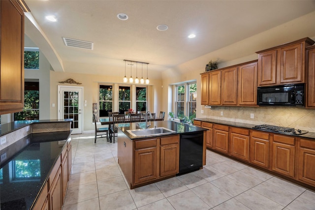 7811 Keith Ln, Sachse, TX 75048 - kitchen featuring black appliances, a sink, tasteful backsplash, brown cabinets, and recessed lighting
