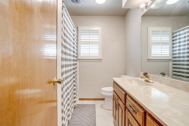 1103 Dirkson St, Weatherford, TX 76086 - full bathroom featuring healthy amount of natural light, toilet, vanity, and tile patterned flooring