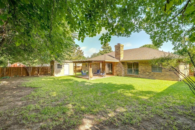 1103 Dirkson St, Weatherford, TX 76086 - back of property with a chimney, a patio area, and brick siding