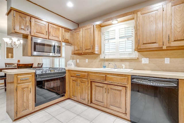 1103 Dirkson St, Weatherford, TX 76086 - kitchen with black appliances, a sink, healthy amount of natural light, and light countertops