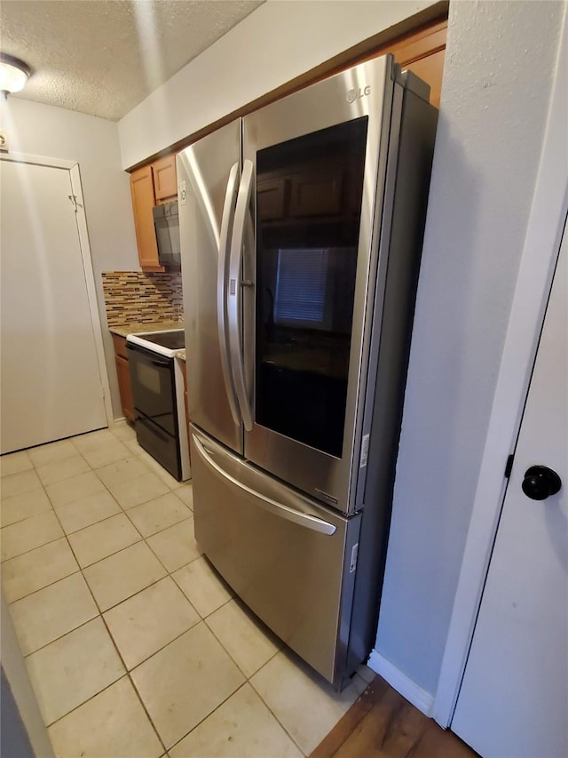 12480 Abrams Rd, Dallas, TX 75243 - kitchen featuring smart refrigerator, range with electric cooktop, light countertops, decorative backsplash, and black microwave