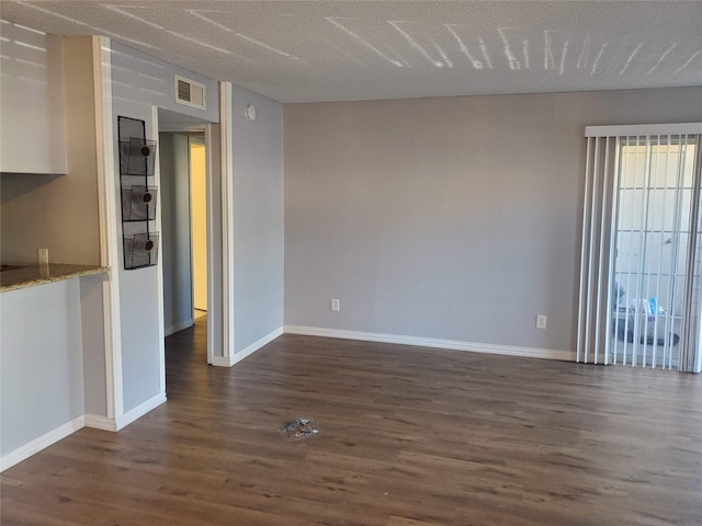 12480 Abrams Rd, Dallas, TX 75243 - unfurnished living room with dark wood-type flooring and baseboards