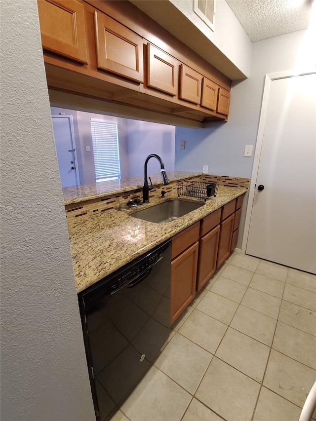 12480 Abrams Rd, Dallas, TX 75243 - kitchen featuring black dishwasher, a sink, light tile patterned flooring, a textured ceiling, and light stone counters