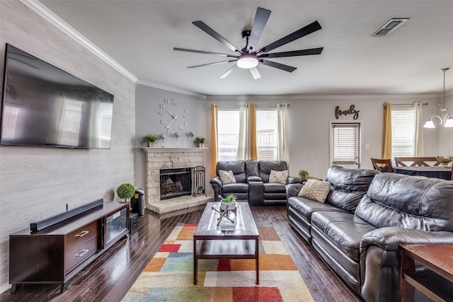 7828 Tudanca Trl, Fort Worth, TX 76131 - living area with plenty of natural light, ceiling fan, crown molding, a fireplace, and a textured ceiling