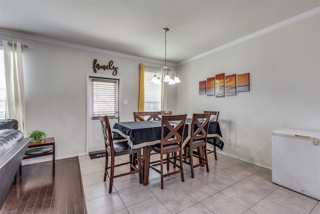 7828 Tudanca Trl, Fort Worth, TX 76131 - dining room featuring a chandelier, crown molding, baseboards, and light tile patterned flooring