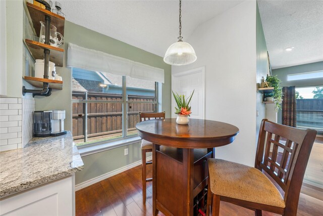11505 Canoe Rd, Frisco, TX 75035 - dining area with wood finished floors, baseboards, and a wood stove
