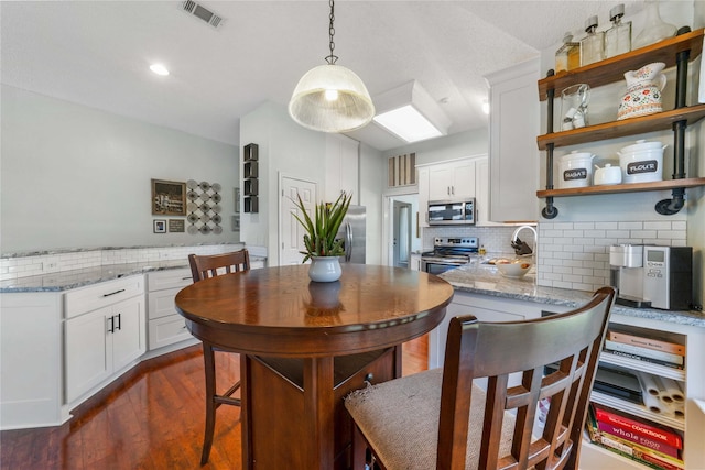 11505 Canoe Rd, Frisco, TX 75035 - dining area with dark wood finished floors and recessed lighting