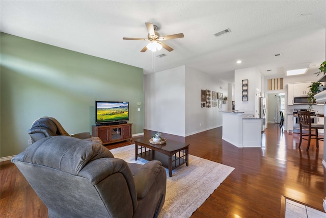 11505 Canoe Rd, Frisco, TX 75035 - living area with dark wood-style floors, a ceiling fan, and baseboards