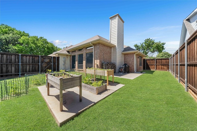 11505 Canoe Rd, Frisco, TX 75035 - rear view of property featuring brick siding, a patio, a chimney, and a garden