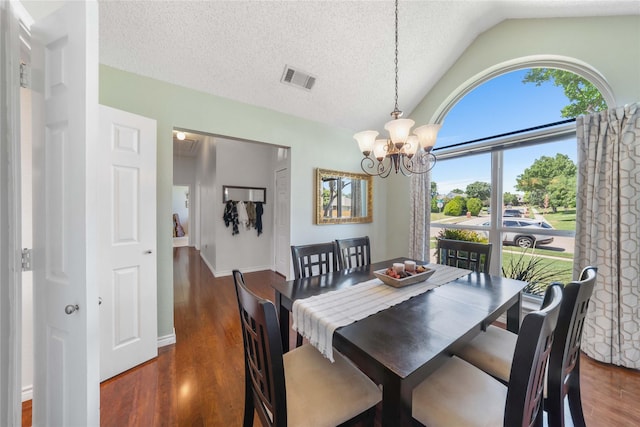 11505 Canoe Rd, Frisco, TX 75035 - dining area with lofted ceiling, a chandelier, wood finished floors, and a textured ceiling