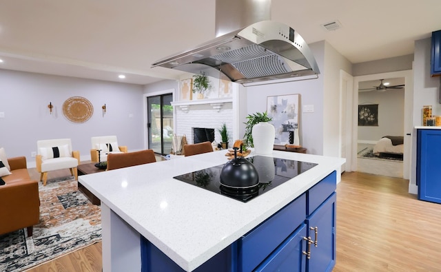 6519 Club Wood, Dallas, TX 75237 - kitchen featuring blue cabinetry, black electric stovetop, ventilation hood, light wood finished floors, and recessed lighting