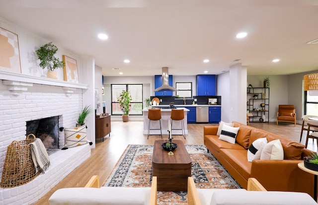 6519 Club Wood, Dallas, TX 75237 - living room with light wood-style floors, healthy amount of natural light, recessed lighting, and a brick fireplace