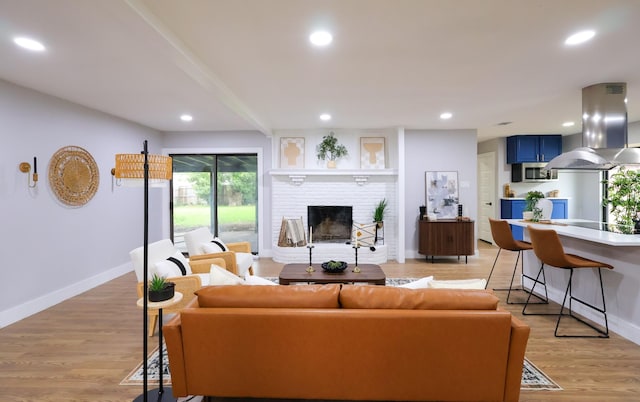 6519 Club Wood, Dallas, TX 75237 - living room with baseboards, a brick fireplace, recessed lighting, and light wood-type flooring