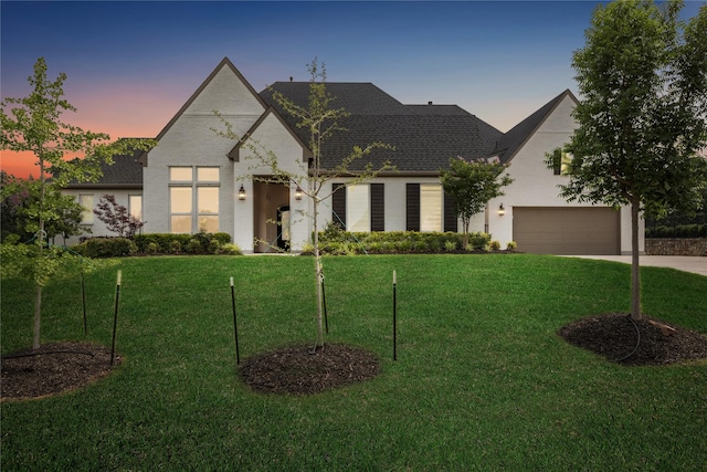 3705 Melville Cir, Flower Mound, TX 75022 - french country style house featuring driveway, a yard, roof with shingles, and a garage