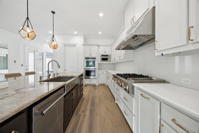 3705 Melville Cir, Flower Mound, TX 75022 - kitchen with appliances with stainless steel finishes, under cabinet range hood, a sink, white cabinetry, and recessed lighting