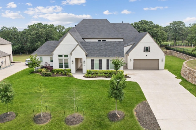 3705 Melville Cir, Flower Mound, TX 75022 - french country inspired facade with concrete driveway, a garage, a front lawn, stucco siding, and roof with shingles