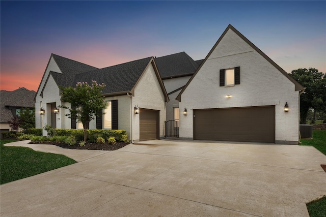 3705 Melville Cir, Flower Mound, TX 75022 - view of front facade with brick siding, driveway, central air condition unit, and roof with shingles