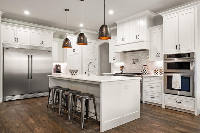 116 Estancia Ct, Decatur, TX 76234 - kitchen featuring premium appliances, custom exhaust hood, light countertops, backsplash, and white cabinets