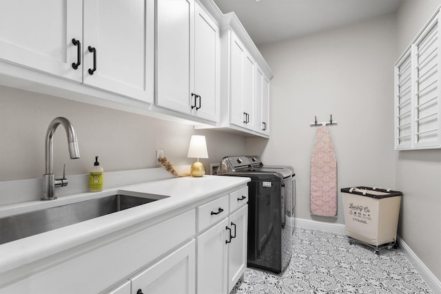 116 Estancia Ct, Decatur, TX 76234 - laundry area featuring cabinet space, washing machine and clothes dryer, and baseboards