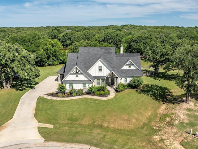 116 Estancia Ct, Decatur, TX 76234 - view of front of property featuring board and batten siding, a forest view, concrete driveway, a front yard, and roof with shingles