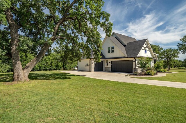 116 Estancia Ct, Decatur, TX 76234 - view of front of home with concrete driveway, an attached garage, a front lawn, board and batten siding, and a shingled roof