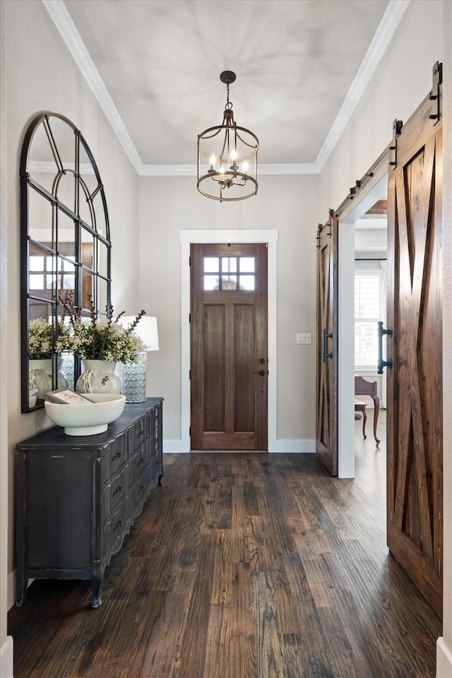 116 Estancia Ct, Decatur, TX 76234 - foyer entrance featuring a barn door, dark wood finished floors, a chandelier, ornamental molding, and baseboards