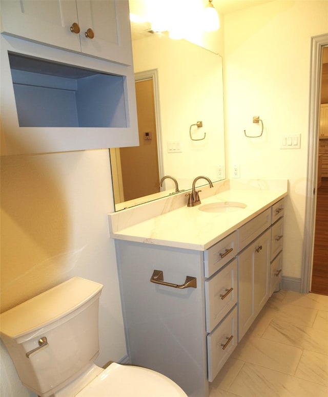 705 Raylan St, Springtown, TX 76082 - bathroom with toilet, vanity, and marble finish flooring