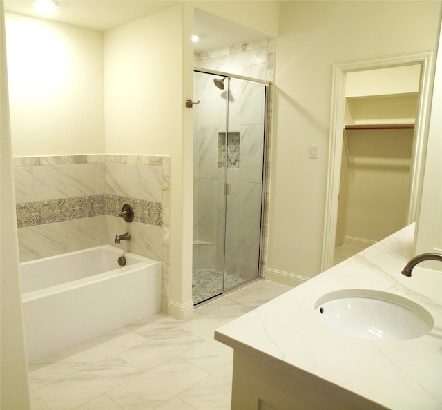 705 Raylan St, Springtown, TX 76082 - bathroom with a bath, a shower stall, double vanity, and a walk in closet