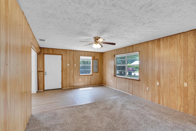 118 Dogwood Trl, Gun Barrel City, TX 75156 - carpeted empty room featuring a ceiling fan, wooden walls, a textured ceiling, and wood finished floors