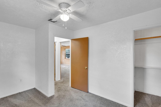 118 Dogwood Trl, Gun Barrel City, TX 75156 - unfurnished bedroom with carpet flooring, a textured ceiling, a closet, ceiling fan, and baseboards