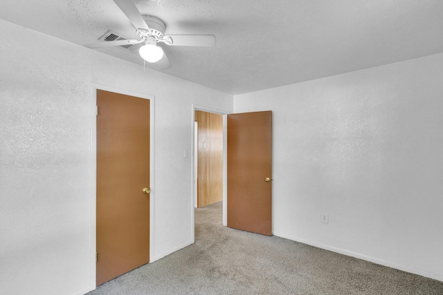118 Dogwood Trl, Gun Barrel City, TX 75156 - unfurnished bedroom featuring carpet, a ceiling fan, and a textured wall