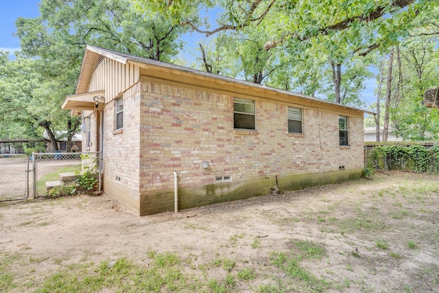 118 Dogwood Trl, Gun Barrel City, TX 75156 - view of side of home featuring crawl space, brick siding, and a gate